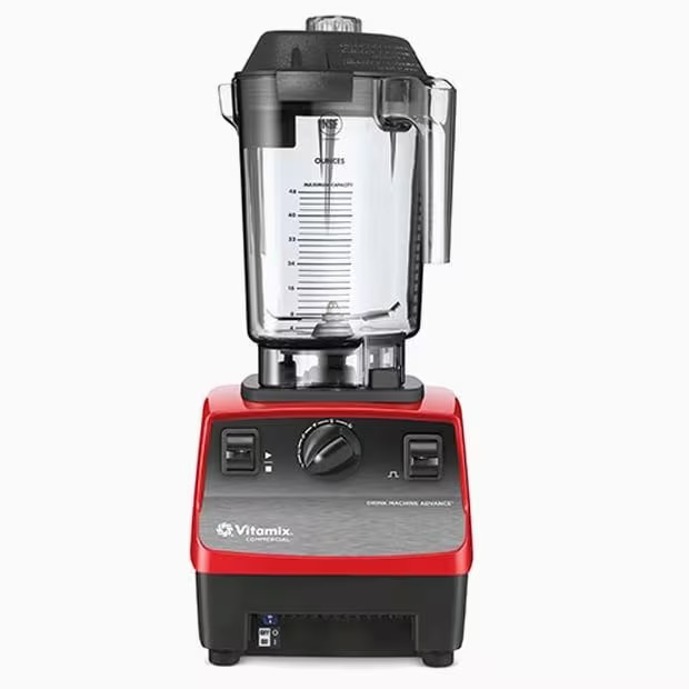 Un blender Vitamix roșu și negru cu o carafă transparentă, gradată, în partea superioară, cadran de control și comutatoare în partea din față, iar marca Vitamix vizibilă la bază.